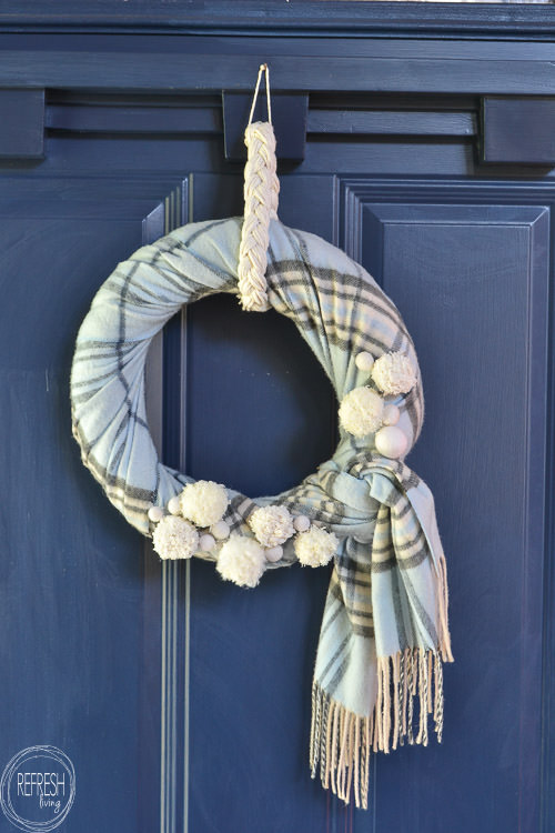 frugal way to decorate your home for winter by wrapping a wreath with flannel scarf