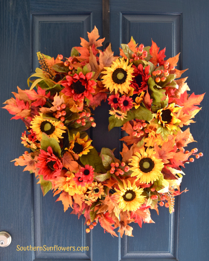 fall updated wreath hanging on front porch door