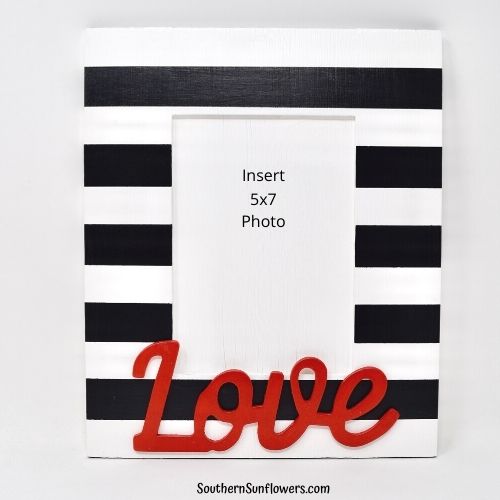 painted picture frame for valentines day with black stripes and love word in red