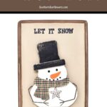 completed diy wooden snowman sign with snowman and "let it snow" saying
