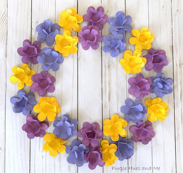 tin can flower wreath in purples in yellow