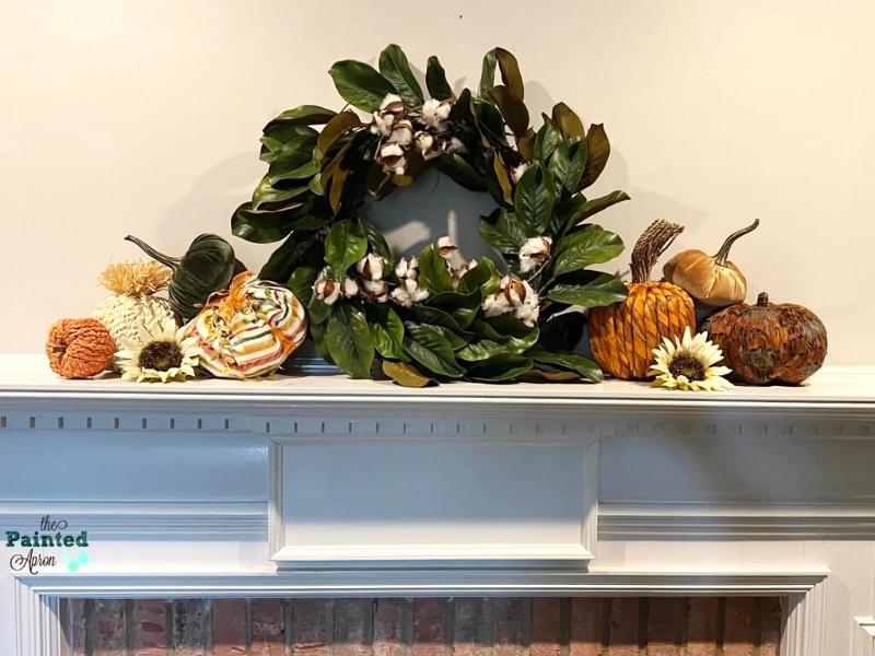 autumn home ideas - fireplace mantel decorated with wreath and pumpkins