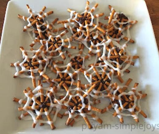 halloween pretzel spider snack on white plate