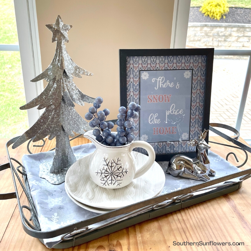 blue, gray and white decorative items displayed on a tray with winter theme