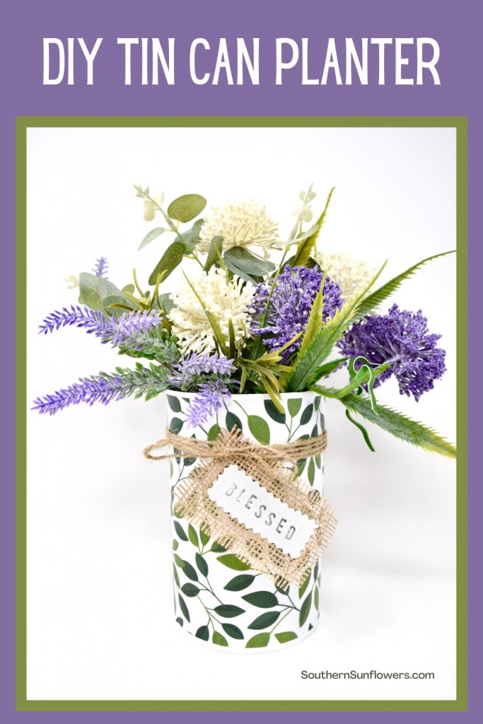 Graphic for a DIY tin can planter using  scrapbook paper and faux flowers.