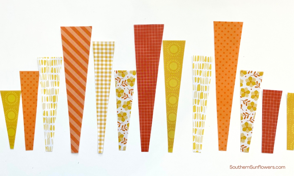 orange and yellow patterened paper strips ready to be applied to the sunburst artwork 