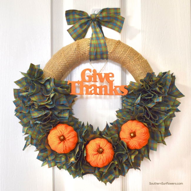 fall wreath using fabric and burlap with pumpkins and a word tag